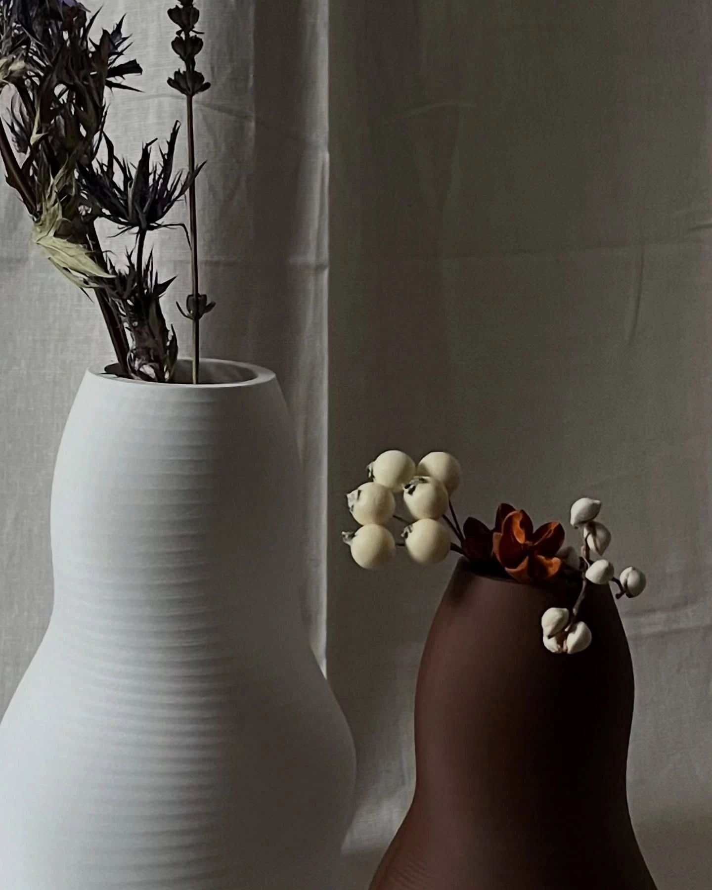 White and chocolate brown Colt vases with dried flowers and berries